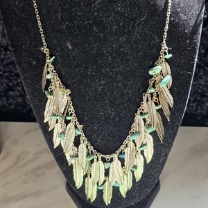 Silver tone feather and faux turquise necklace